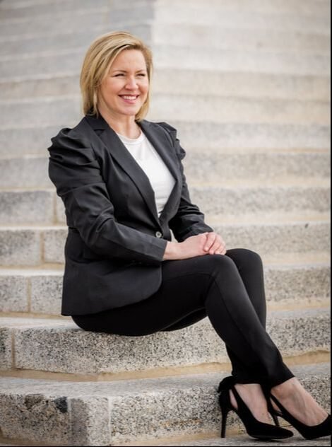 Woman sitting on white steps
